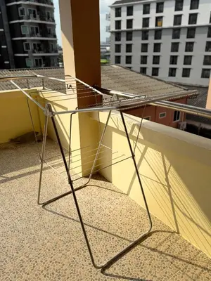 a metal chair sitting on top of a balcony at The President Park Condo Nanai, Patong, Phuket in Patong Beach