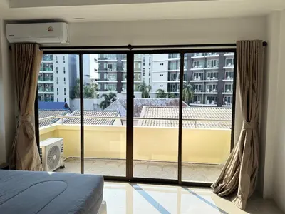 a bedroom with a large window with a view at The President Park Condo Nanai, Patong, Phuket in Patong Beach