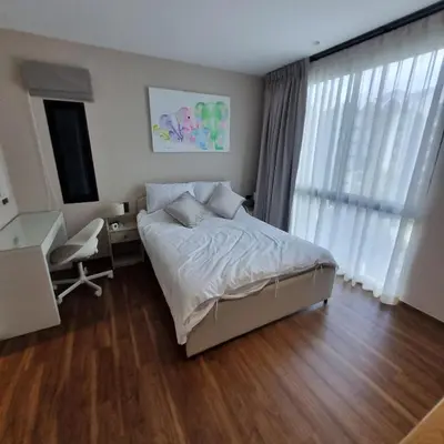 a bedroom with a bed and a desk and a window at Title Halo Nai Yang Тайтл Хало Най Янг operated by OK Group in Nai Yang Beach
