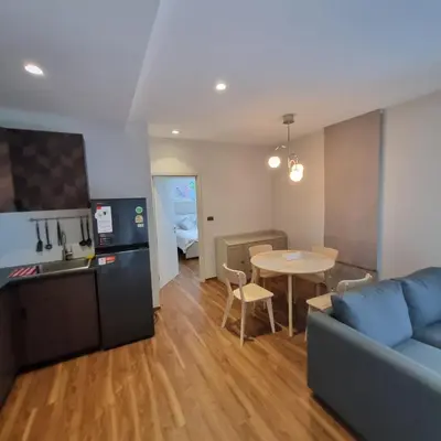 a living room with a couch and a table and a kitchen at Title Halo Nai Yang Тайтл Хало Най Янг operated by OK Group in Nai Yang Beach
