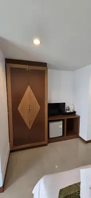 a room with a wooden cabinet with a door at APK Hillview Hotel in Patong Beach