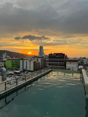 a view of the sunset from the rooftop of a building at APK Hillview Hotel in Patong Beach