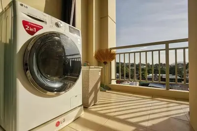 a washing machine in a room with a balcony at Phuket Avenue in Phuket Old Town in Phuket Town