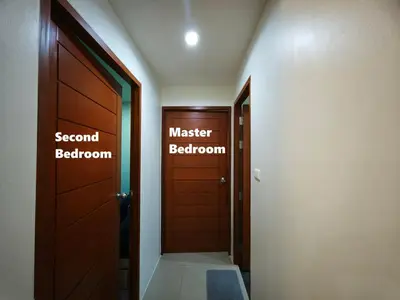a hallway with a door and a master bathroom at Phuket Avenue in Phuket Old Town in Phuket Town