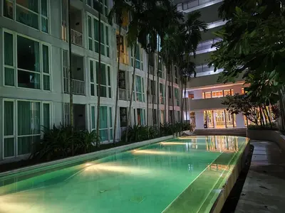 a swimming pool in front of a building at 4 Floor - The Base Downtown Condominium next to Central Shopping Mall in Phuket Town