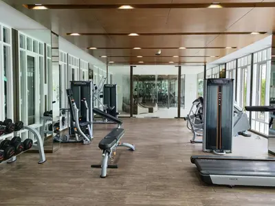 a gym with several treadmills and cardio machines at 4 Floor - The Base Downtown Condominium next to Central Shopping Mall in Phuket Town