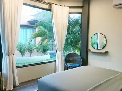 a bedroom with a bed and a large window at Ingsala by CafeAtLuv22 in Ban Bo Rae
