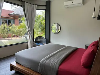 a bedroom with a bed and a large window at Ingsala by CafeAtLuv22 in Ban Bo Rae