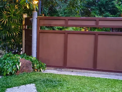 a fence in a yard with green grass at Ingsala by CafeAtLuv22 in Ban Bo Rae