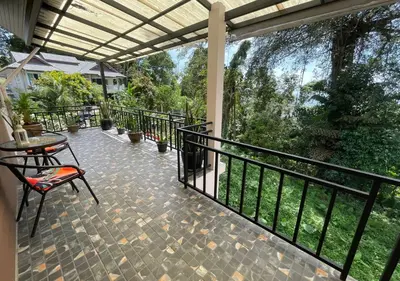 a patio with a table and chairs on a balcony at Charming and Exotic Seaview 2-Bedroom House in Patong in Patong Beach