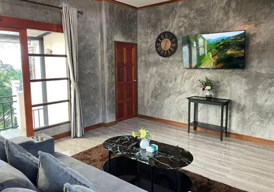 a living room with a couch and a table at Charming and Exotic Seaview 2-Bedroom House in Patong in Patong Beach