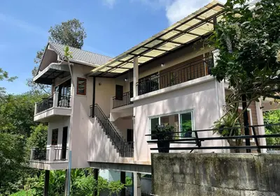 a white building with balconies and stairs on it at Charming and Exotic Seaview 2-Bedroom House in Patong in Patong Beach
