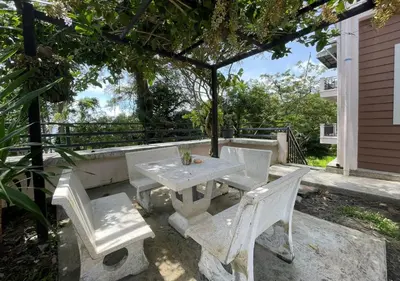 a picnic table and chairs under a gazebo at Charming and Exotic Seaview 2-Bedroom House in Patong in Patong Beach