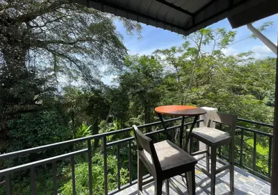 a balcony with a table and two chairs at Charming and Exotic Seaview 2-Bedroom House in Patong in Patong Beach