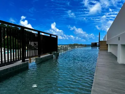 a large body of water next to a building at Palmetto Park Condominium in Karon Beach