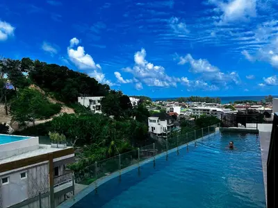 a view of a swimming pool from a building at Palmetto Park Condominium in Karon Beach
