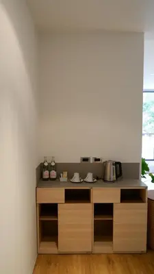 a kitchen with a counter with bottles and pans at The Lush Apartments & Suites in Pilai Beach