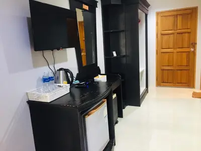 a kitchen with black cabinets and a black counter top at Srisuksan Klong Muang Beach in Klong Muang Beach