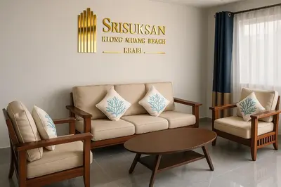a living room with a couch and two chairs and a table at Srisuksan Klong Muang Beach in Klong Muang Beach