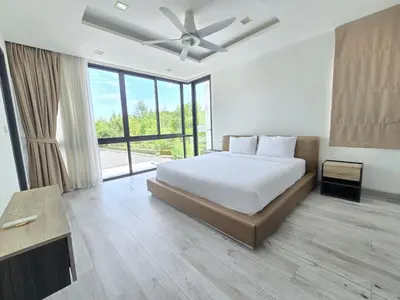 a bedroom with a bed and a ceiling fan at Laguna Park 2 Villa 3 bedroom in Ban Phru Champa