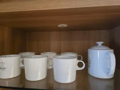a group of white coffee cups sitting on a shelf at Laguna Lakeside BangTao Лагуна Лейксайд Lagoona operated by OK Group in Bang Tao Beach