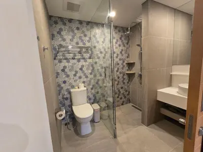 a bathroom with a toilet and a glass shower at Laguna Lakeside BangTao Лагуна Лейксайд Lagoona operated by OK Group in Bang Tao Beach