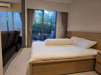 a bedroom with a bed and a large window at Laguna Lakeside BangTao Лагуна Лейксайд Lagoona operated by OK Group in Bang Tao Beach