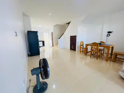 a kitchen and dining room with a fan in a living room at Winlee house in Ban Phlu Yai