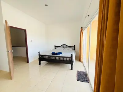 a bedroom with a bed in a room at Winlee house in Ban Phlu Yai