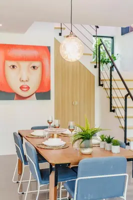 a dining room with a wooden table and blue chairs at Harmony Exclusive Villa Bang Tao Phuket in Ban Thalat Choeng Thale