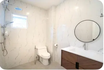 a bathroom with a toilet and a sink and a mirror at Patong Seven Heaven in Patong Beach