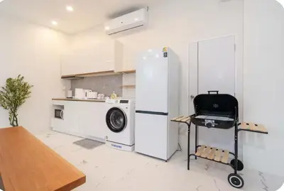 a kitchen with a refrigerator and a washing machine at Patong Seven Heaven in Patong Beach