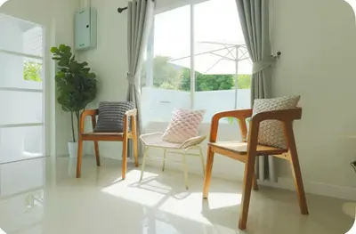 a living room with three chairs and a window at Patong Seven Heaven in Patong Beach