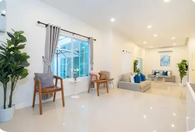 a living room with chairs and a large window at Patong Seven Heaven in Patong Beach