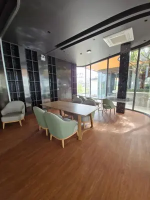 a conference room with a table and chairs and windows at Bellevue Lagoon Phuket 212 Bang tao operated by OK Group in Laguna Phuket