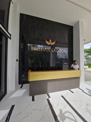 a man sitting at a reception desk in a building at Bellevue Lagoon Phuket 212 Bang tao operated by OK Group in Laguna Phuket