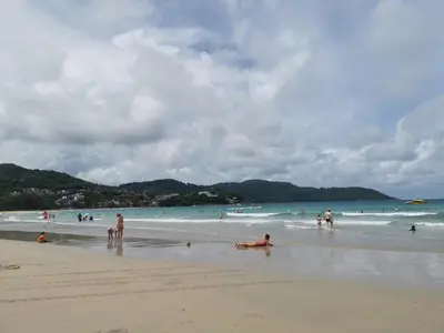 a group of people playing in the water on a beach at 6 Floor - Studio room at OZC near Kata beach in Kata Beach