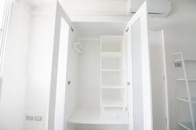 a white closet with white shelves and ceilings at Spacious 2 Bedrooms 360deg Mountain-View Apartment in Ban Klang