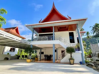 a large white building with a red roof at Kata Tropical Heights Villa - 4BR Private Pool in Kata Beach