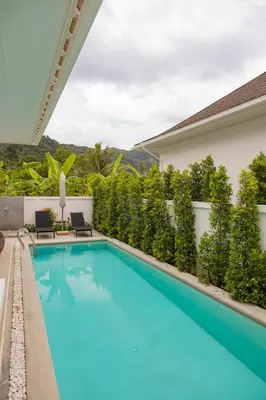 a swimming pool in the backyard of a house at Tantawan house - Kamala beach in Kamala Beach