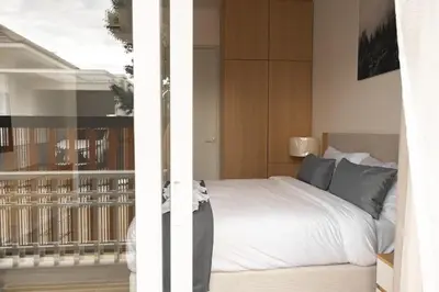 a bedroom with a bed and a balcony at Tantawan house - Kamala beach in Kamala Beach