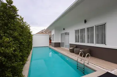 a swimming pool in the backyard of a house at Tantawan house - Kamala beach in Kamala Beach