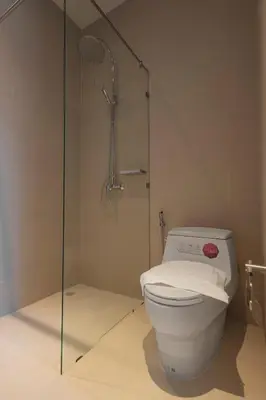 a bathroom with a toilet and a glass shower at Tantawan house - Kamala beach in Kamala Beach