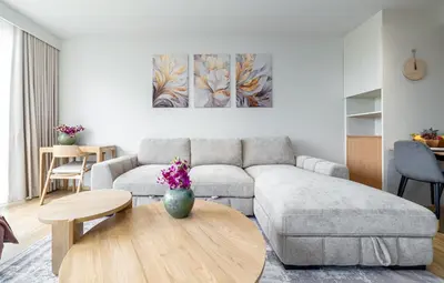 a living room with a couch and a table at Beachside 1 bedroom apartment 200 meters to Bang Tao Beach Manage by OCEAN HUB in Ban Thalat Choeng Thale