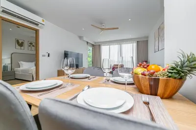 a dining room table with a bowl of fruit on it at Beachside 1 bedroom apartment 200 meters to Bang Tao Beach Manage by OCEAN HUB in Ban Thalat Choeng Thale