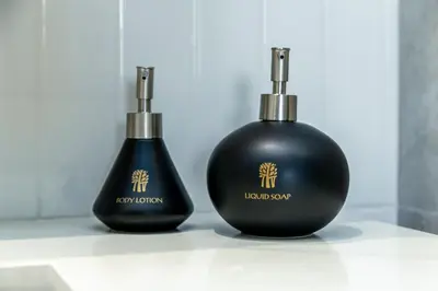 two black soap bottles sitting next to each other at Beachside 1 bedroom apartment 200 meters to Bang Tao Beach Manage by OCEAN HUB in Ban Thalat Choeng Thale