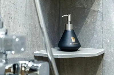 a soap dispenser sitting on a shelf in a bathroom at Beachside 1 bedroom apartment 200 meters to Bang Tao Beach Manage by OCEAN HUB in Ban Thalat Choeng Thale