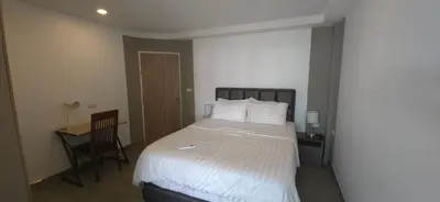 a bedroom with a bed and a desk and a chair at Andaman Seaview house rooftop 2 in Patong Beach
