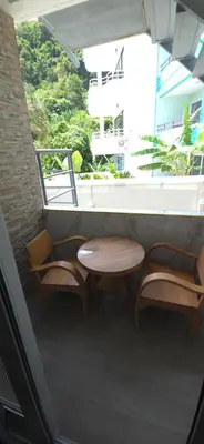 a table and two chairs on a balcony at Andaman Seaview house rooftop 2 in Patong Beach