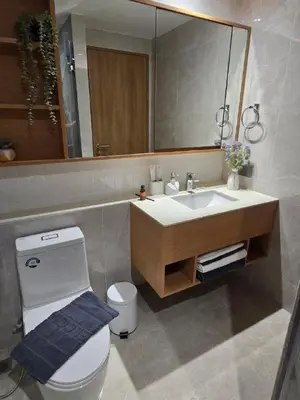 a bathroom with a toilet and a sink and a mirror at Beachside Lagoon Bang Tao Laguna by OK group in Ban Thalat Choeng Thale